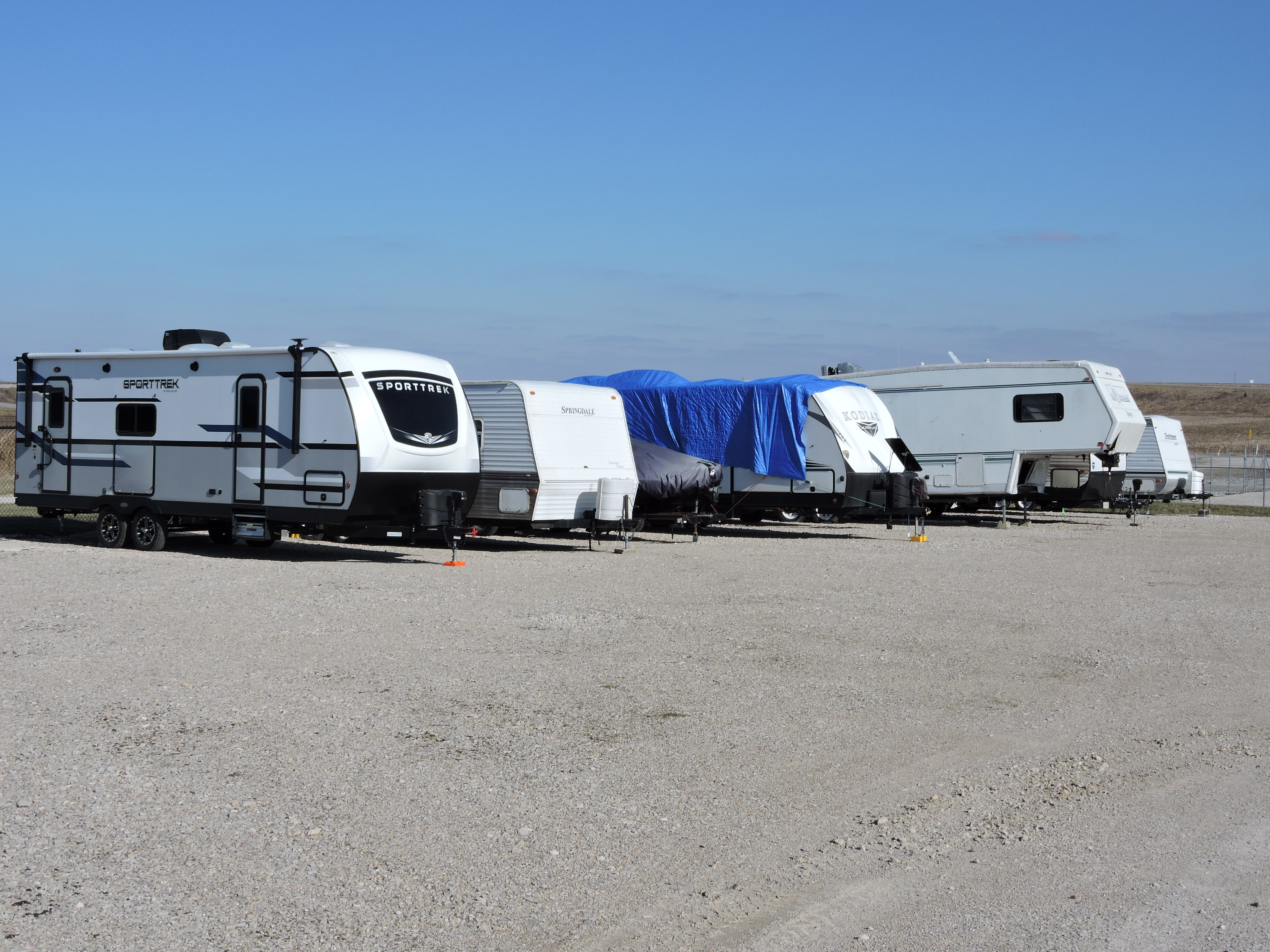 Washington, IN's Access Storage featuring a secure, fenced parking zone dedicated to boats and RVs, ensuring protected storage space.